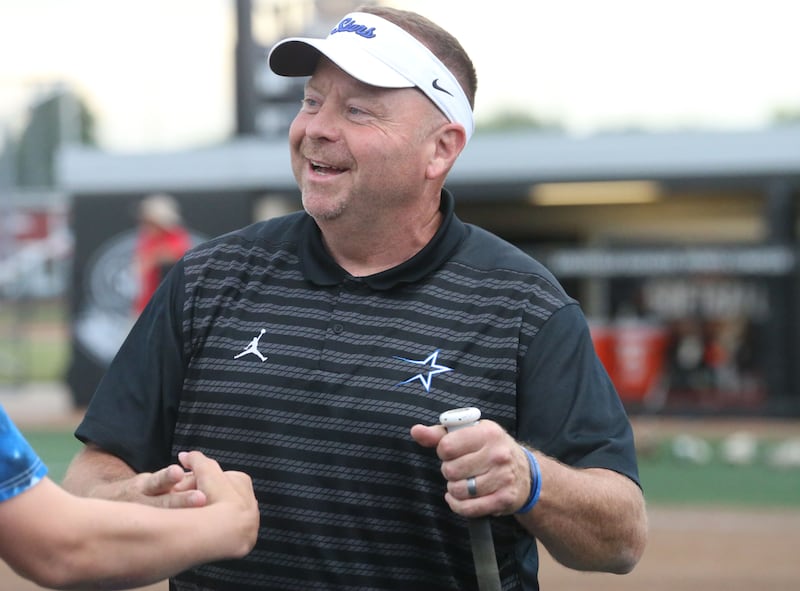 St. Charles North head softball coach tom Poulin smiles while walking off of the field as his team defeated Oswego during the Class 4A semifinal game on Friday, June 7, 2024 at the Louisville Slugger Sports Complex in Peoria.