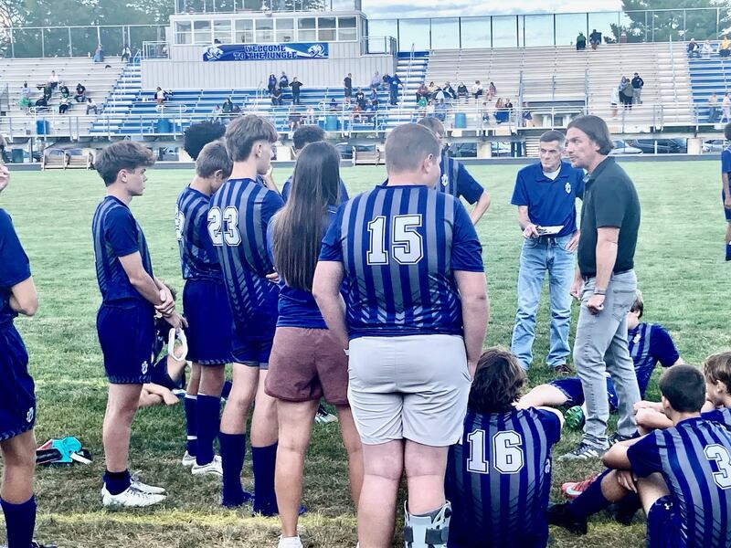 Princeton coach David Gray (right) talks to the Tigers following Tuesday's 6-0 loss to Alleman at Bryant Field.