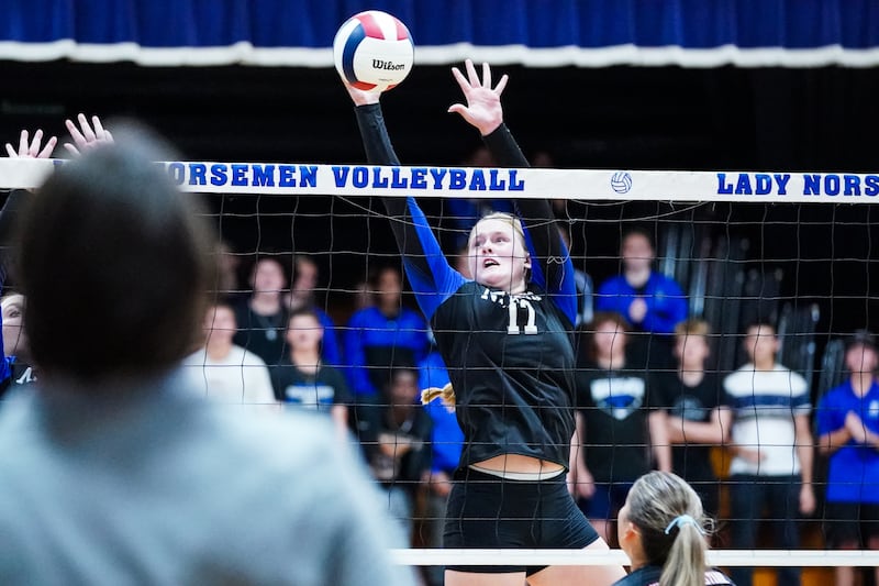 Newark’s Zoey Carlson (17) defends the net blocking a kill attempt during a non-conference match against Aurora Christian at Newark High School on Tuesday, Sept. 9, 2025.