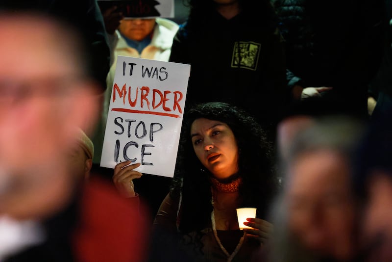 A demonstrator holds a sign during a candlelight vigil during a protest in response to the fatal shooting of 37-year-old Alex Pretti in Minneapolis earlier in the day Saturday, Jan. 24, 2026, in Los Angeles. (AP Photo/Caroline Brehman)