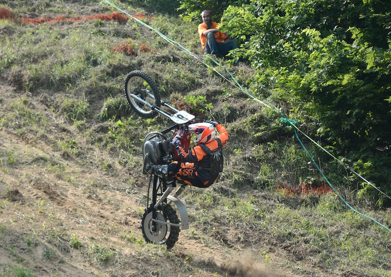 Wade Schultz of Lisbon, Iowa, hangs on as his motorcycle goes vertical during a run at the Rock River Riders Motorcycle Club's hillclimb on Sunday, Aug. 3, 2025.