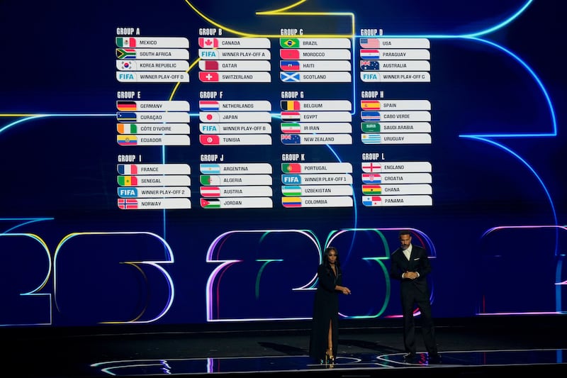 Broadcaster Samantha Johnson and former England soccer captain Rio Ferdinand speak during the draw for the 2026 soccer World Cup at the Kennedy Center in Washington, Friday, Dec. 5, 2025. (AP Photo/Chris Carlson)