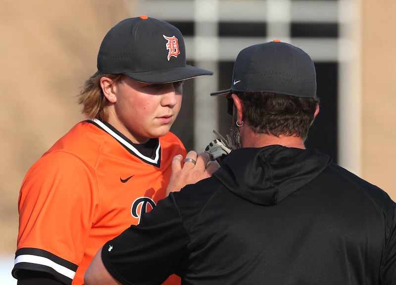 DeKalb head coach Josh Latimer goes to the mound to talk to DeKalb's Brodie Farrell Monday, April 28, 2025, during their game against Naperville Central at DeKalb High School.