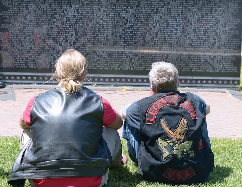 Many who participated in the Annual Illinois Motorcycle Freedom Run, sat with a moment of reflection Saturday at the granite Middle East Conflicts Wall Memorial that has over 8,000 names of those who lost their lives etched in the wall.