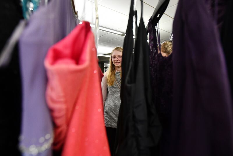 Madeline Shold, 15, of Bourbonnais, looks at dresses on the racks of the Bradley Public Library’s 2022 Say Yes to the Prom Dress event.