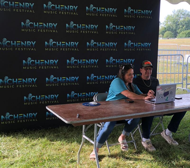 McHenry Music Fest co-founder and McHenry Mayor Wayne Jett, right, and Kelsey Adams, who assisted with the festival and oversaw a volunteer team, give reminders for traffic and rules on Wednesday, Sept. 10, 2025, before the concert weekend kicked off at Petersen Park.