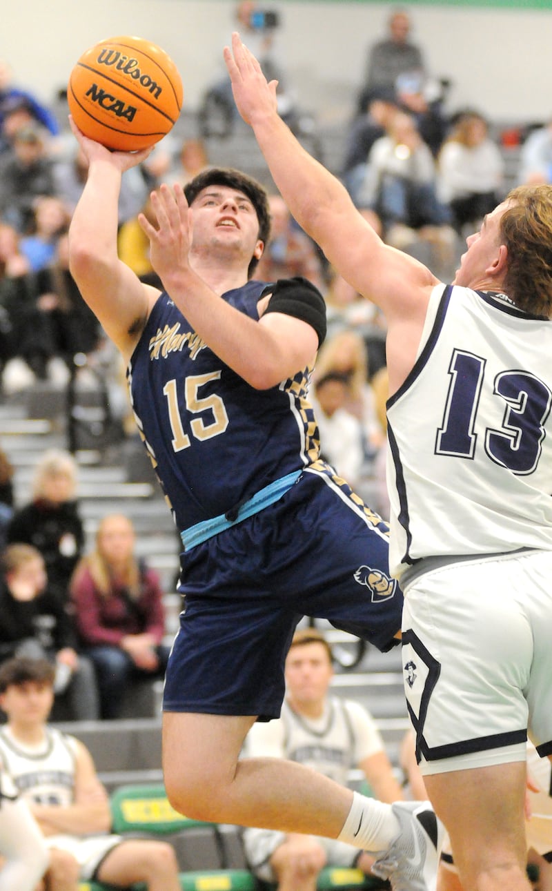 Marquette's Alec Novotney (15) shoots as Lexington's Joe Cheever appliea pressure in the Shipyard Showdown semifinals on Friday, Dec. 26, 2025 in Seneca.