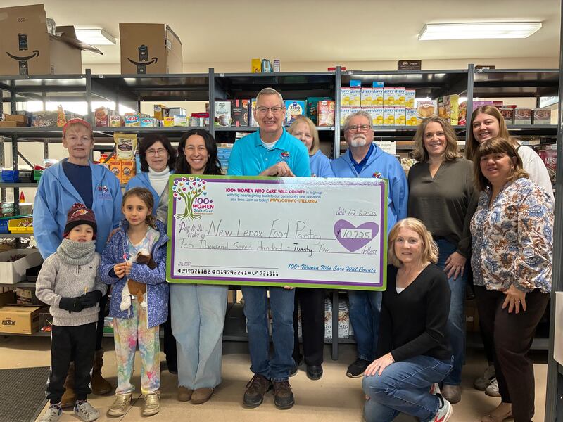 Members of 100+ Women Who Care of Will County had their “big check” presentation donating $10,725 to the New Lenox Family Services Food Pantry on Dec. 22, 2025.