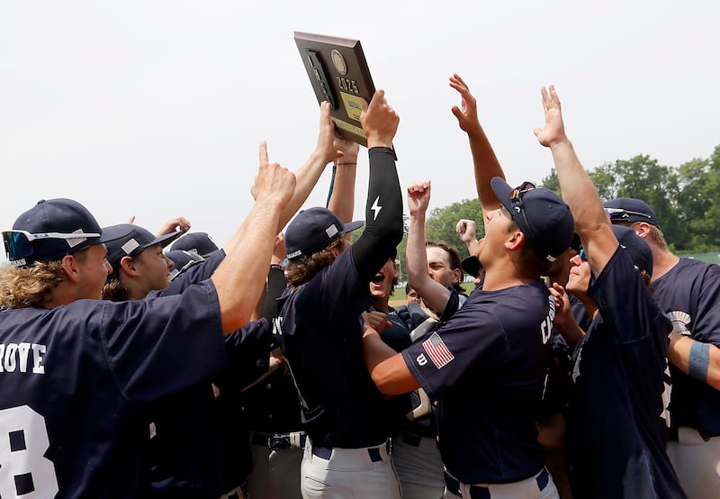 Cary-Grove's Kaden Norman raises the trophy after Cary-Grove defeated Crystal Lake South in the IHSA Class 3A Grayslake Central Sectional Championship baseball game on Saturday, June 7, 2025, at Grayslake Central High School.