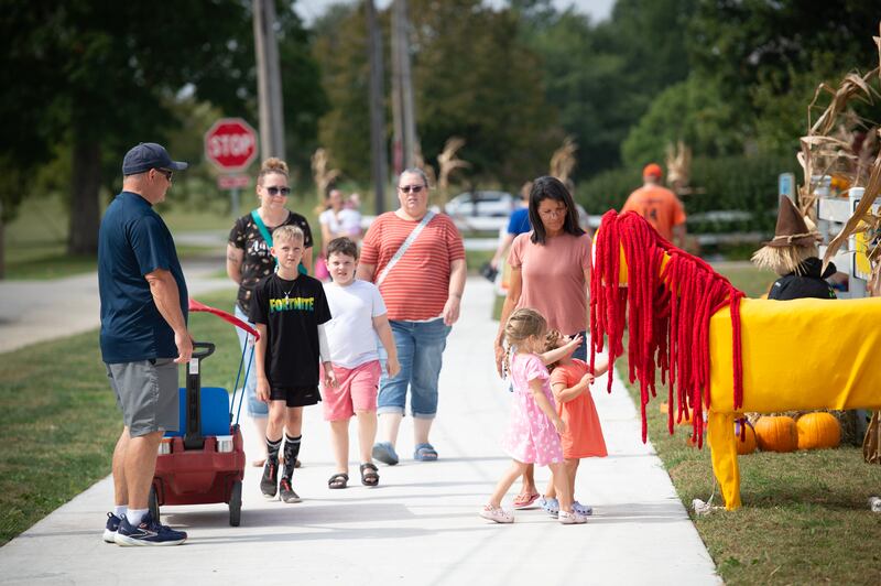 People stop to check out the scare crows at Perry Farm during the Fall Art Stroll and scare crow voting on Sunday, September 21, 2025.