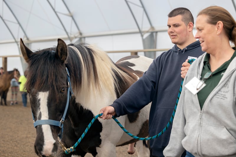 Riley leads a horse around the ring Tuesday, May 6, 2025, during the outing at Pegasus Special Riders.