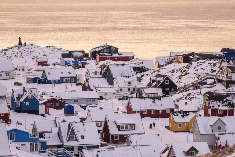 People walk on a street in Nuuk, Greenland, Wednesday, Jan. 14, 2026. (AP Photo/Evgeniy Maloletka)