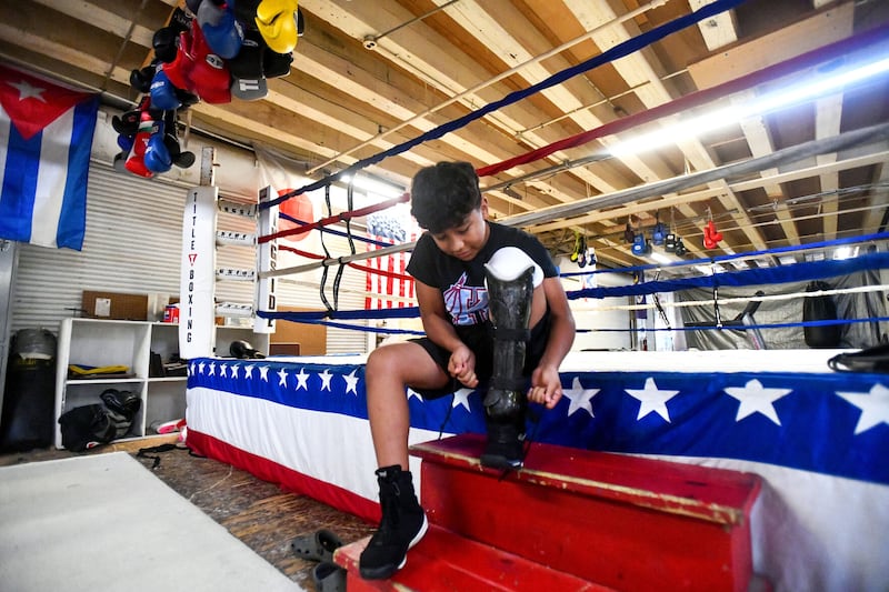 Jose Vasquez, 13, of Kankakee, prepares for a training session at Gold Star Gym on July 9. Vasquez, who is missing the lower part of his left leg due to a lawnmower accident, was the first amputee to be awarded a USA Boxing license as a junior boxer.