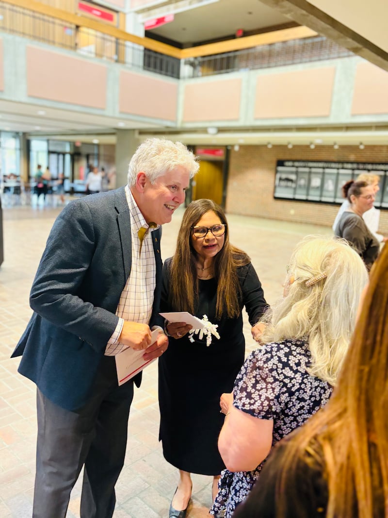 Sauk Valley Community College President Dave Hellmich and Ana Lara greet students June 3, 2025, at the college's adult education graduation ceremony.