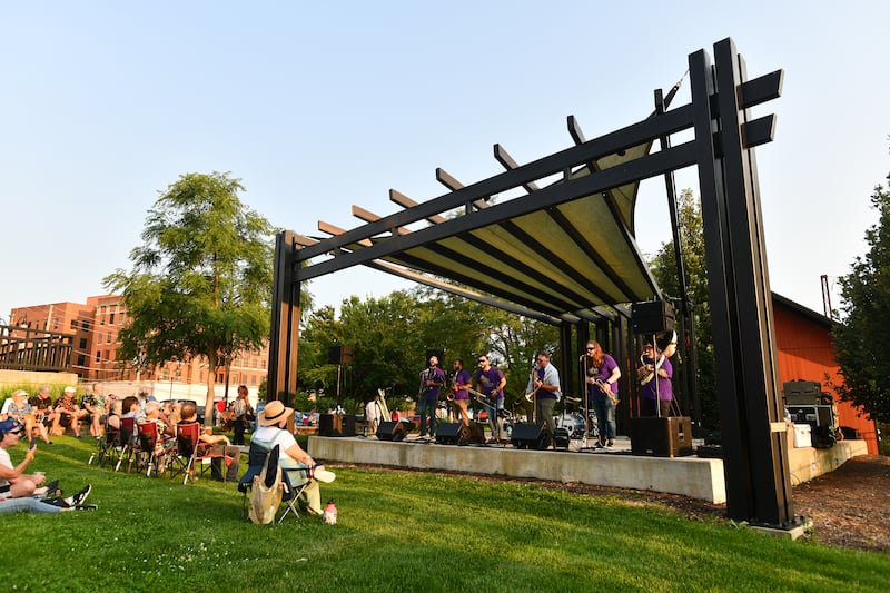 Attendees listen to Third City Brass Band perform on the Hill Stage on July 23, 2024 during the monthly installment of Friday Night Concert Series, hosted by Downtown Kankakee.