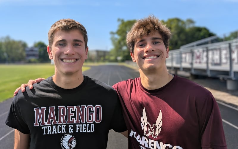 Marengo identical twins Grant (left) and Jackson Heimsoth pose for a picture on the track Saturday, May 16, 2026, at Marengo High School. The brothers have excelled in sprint races this season.