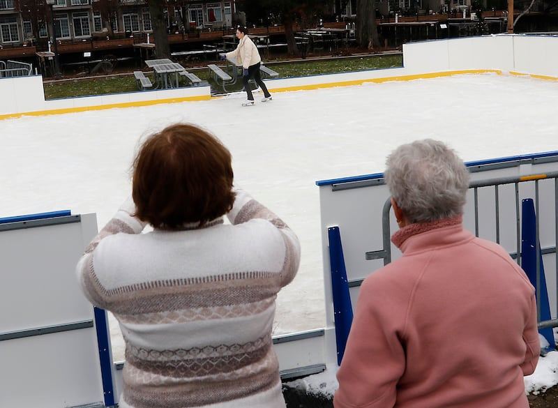 Family members watch as Natasha Lamprecht skates on Dec. 5, 2023, at the Miller Point Park Ice Skating rink in McHenry.