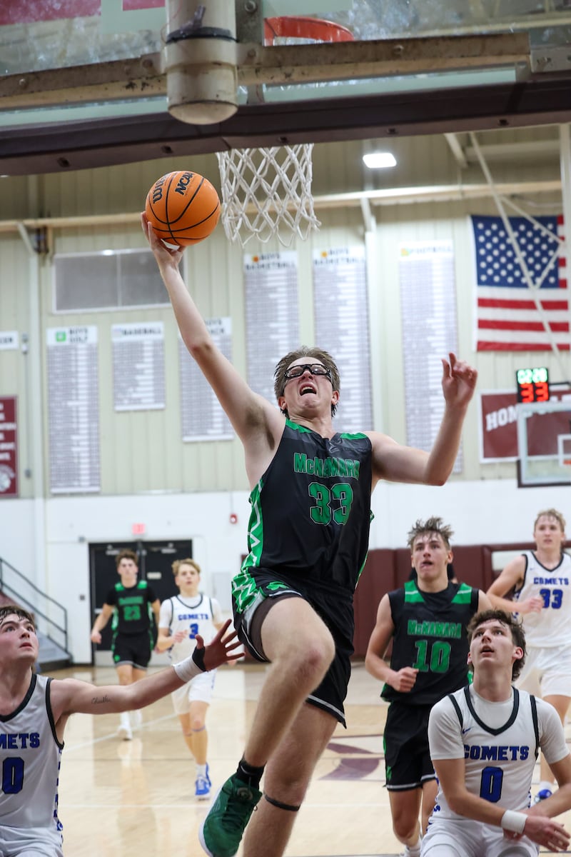 Bishop McNamara's Callaghan O'Connor goes up for a dunk past Clifton Central players during the Fightin' Irish's 62-41 victory in the Watseka Holiday Tournament championship on Tuesday, Dec. 16, 2025.