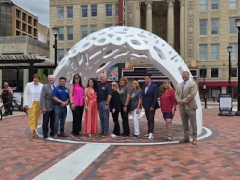 Mayor Terry D'Arcy and other Joliet city officials stand under the Dome of Unity sculpture during the official dedication of the City Square in downtown Joliet on Thursday, June 18, 2026. The square opened for on May 1.