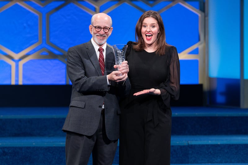 Tom Wadsworth (left) receives the Scripps National Spelling Bee National Volunteer of the Year award from Corrie Loeffler, executive director of the Scripps National Spelling Bee, on Monday, May 26, in Washington.