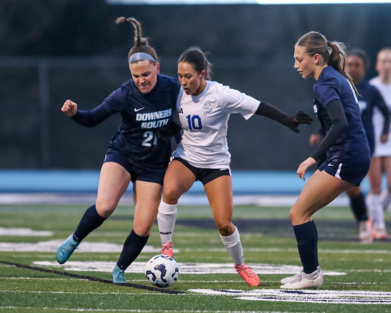 Downers Grove South's Mallory Crowley (21) and Riverside-Brookfield's Ella Caputo (10) fight for the ball during soccer match between Riverside-Brookfield at Downers Grove South. April 10, 2025.
