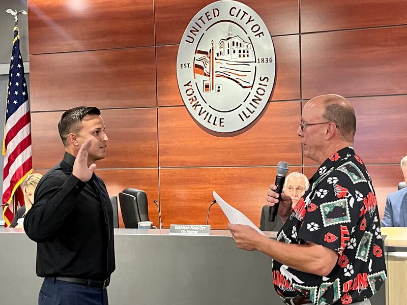 The Yorkville Police Department's newest hire, David Diaz, is administered the oath of office by Yorkville Mayor John Purcell.