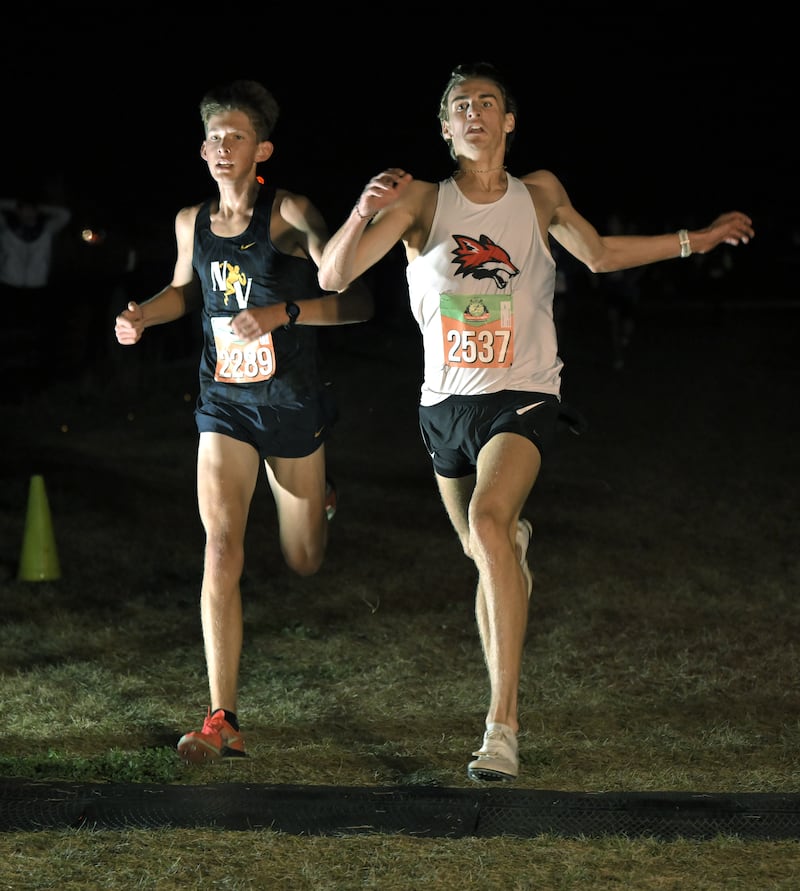 Owen Horeni of Yorkville edges Jesse Gudauskas of Nequa Valley for second place in the boys varsity race at the annual Naperville North Twilight Cross Country meet, this year at Settler’s Hill in Geneva on Wednesday, Oct. 8, 2025.