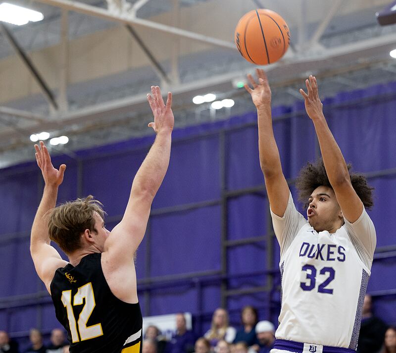 Dixon’s Darius Harrington puts up a shot against Elk Grove’s Dan Pasterski Saturday, Jan. 11, 2025, at Dixon High School.