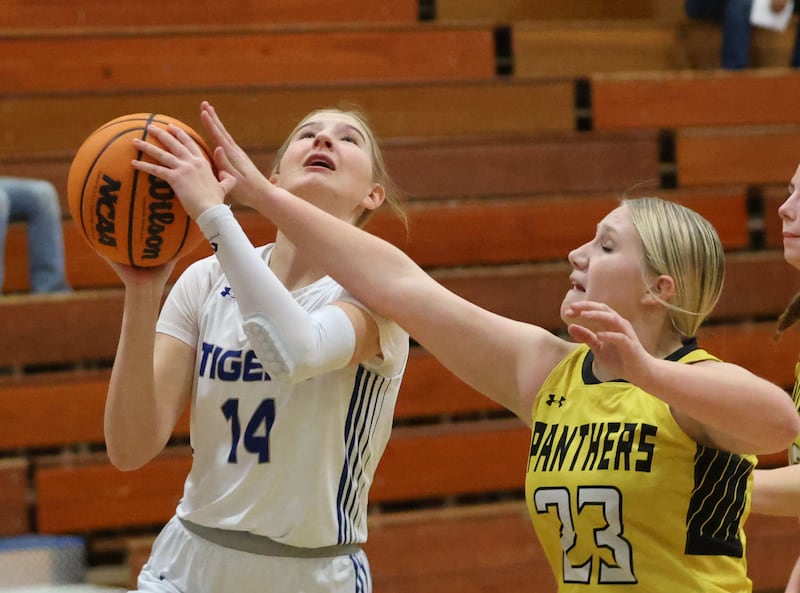 Princeton's Payton Brandt, eyes the hoop in the lane as Putnam County's Emberlyn Cwikla defends during the Tiger Girls Basketball Holiday Tournament on Tuesday, Nov. 18, 2025 at Princeton High School.