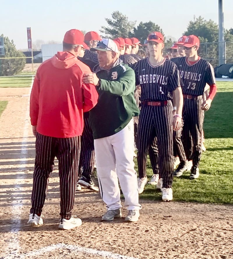 St. Bede coach Bill Booker greets Hall coach Tom Keegan (left) following Wednesday's game at Schweickert Stadium in Peru. The rival Bruins and Red Devils rallied together in support of Hall senior Jax LaVelle in his battle with cancer.