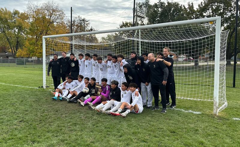 The Streamwood boys soccer team poses with a Class 2A regional plaque after winning the Crystal Lake Central regional title