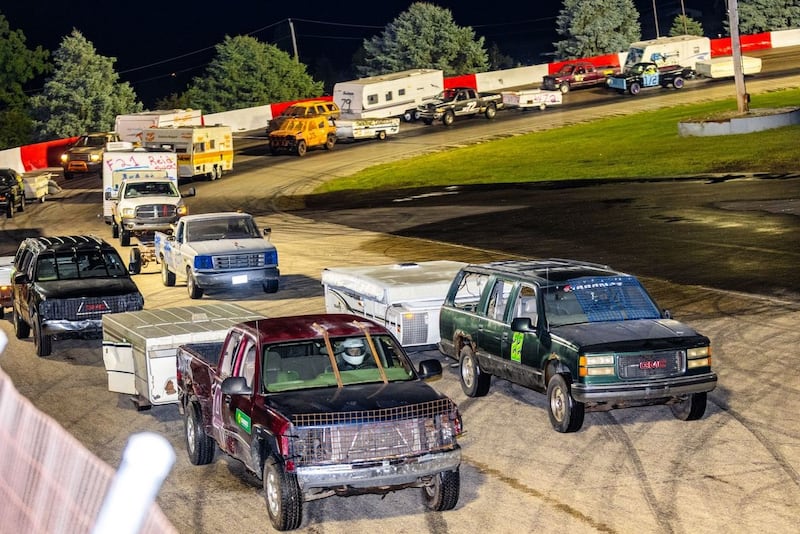 Trucks and their trailers race around the figure eight track during the World Famous Figure 8 Trailer Race of Destruction.