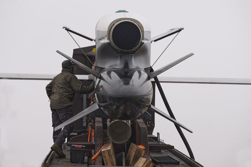 Workers and military inspect Ukrainian Fire Point's Flamingo missiles during handover to the military in an undisclosed location in Ukraine Thursday, Dec. 4, 2025. (AP Photo/Efrem Lukatsky)