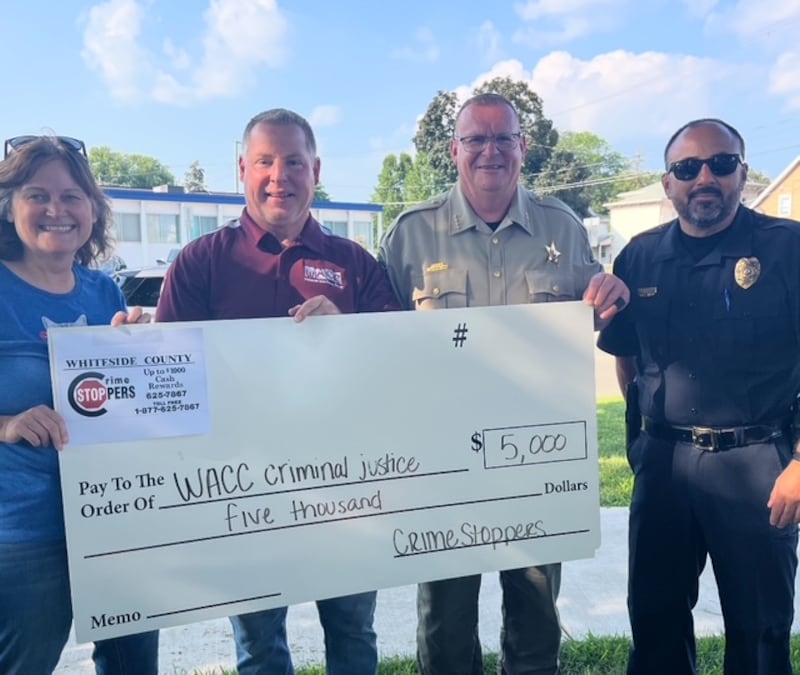 Whiteside County Crime Stoppers present a check in Glenda Bruins' honor to WACC's criminal justice program. Pictured (left to right) Crime Stoppers member Sally Douglas, Criminal Justice Coordinator Mike Wolfley, Sheriff John Booker and Chief Alex Chavira.