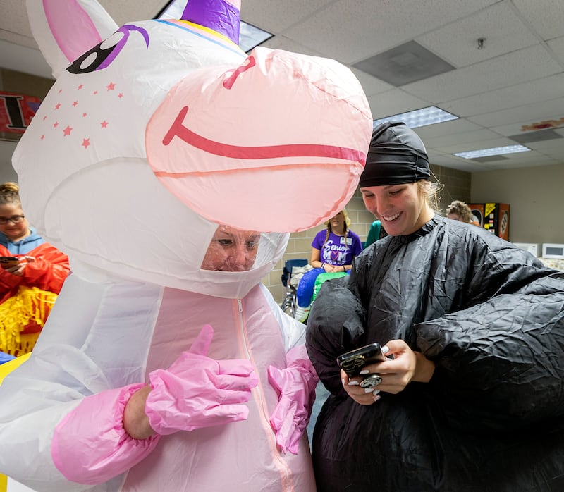 Christy Zepezauer (left) and Jaylee Dugger go over how to post a Tik Tok Wednesday, May 21, 2025, while waiting for their students at Reagan Middle School.
