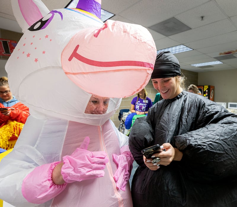 Christy Zepezauer (left) and Jaylee Dugger go over how to post a Tik Tok Wednesday, May 21, 2025, while waiting for their students at Reagan Middle School.