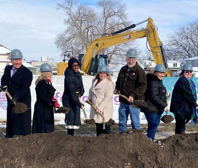 Officials including Ringland-Johnson Construction CEO Brent Johnson (from left); Christine Kaline of Safe Passage Inc.; U.S. Rep. Lauren Underwood, D-Naperville; and Rebecca Versluys, executive director of Safe Passage, break ground Friday, Dec. 5, 2025, on construction of the crisis shelter's new building at 217 S. Franklin St., in DeKalb.