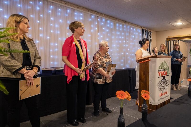 YWCA Executive Director Rebecca Munoz-Ripley (middle) starts the ceremony Thursday, April 18, 2024 for the 41st YWCA Women of Achievement Luncheon.