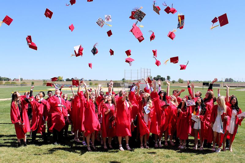 Forreston High School's Class of 2025 toss their caps into the air after exiting the gym at the end of commencement on Sunday, May 18, 2025.