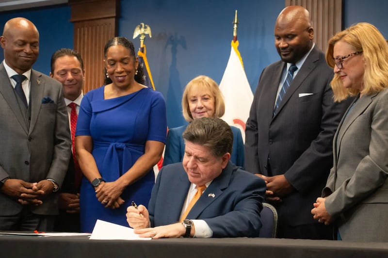 Gov. JB Pritzker signs the fiscal year 2027 budget alongside top state lawmakers during a ceremony in Chicago on June 16, 2026.