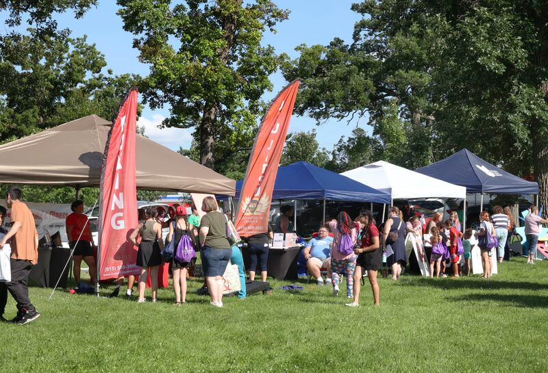 Attendees check out the booths at the Family Fun Fest Wednesday, July 17, 2024, at Hopkins Park in DeKalb.