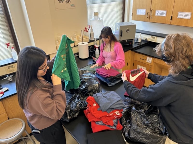 Joliet Central High School Advancement Via Individual Determination students (from left) Paula Rangel, Valerie Ruiz-Flores and Tyler Swearingen sort clothing for the community-wide thrift sale to be held in the Joliet West High School Cafeteria on Friday and Saturday, May 8-9, 2026.