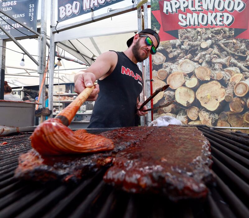 Mojos Famous BBQ, Grill Master, Guy Wilkinson puts some sauce on the ribs during Lake in the Hills RockinÕ Rotary Ribfest Saturday, July 12, 2025 in Lake in the Hills.