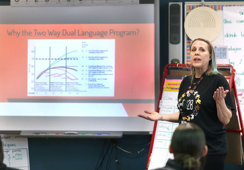AJ Crook, Multilingual Programs Coordinator for School District 428, talks to parents Tuesday, March 11, 2025, at Cortland Elementary School, about the districts two-way dual language program during an informational open house on the subject.