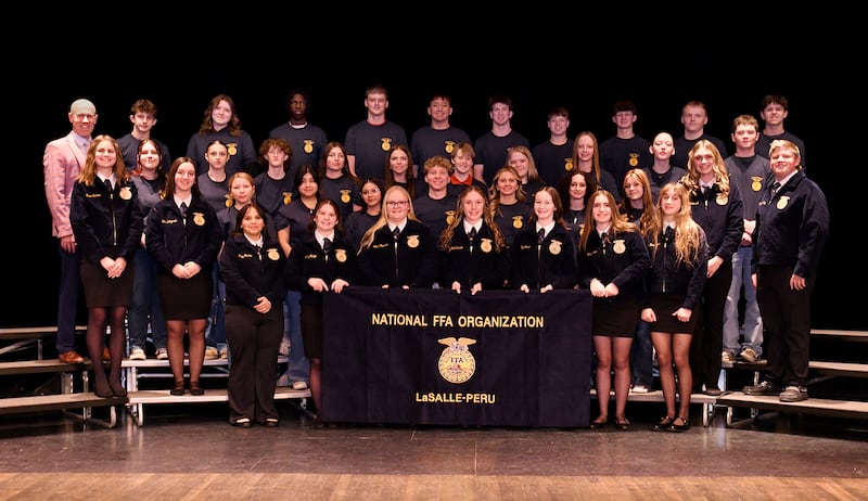 Riley Hintzsche, agriculture teacher and FFA Advisor at La Salle-Peru Township High School, works with students in the agricultural classroom. Hintzsche was awarded a $5,000 CASE Implementation Grant from Corteva Agriscience to expand hands-on learning opportunities and purchase equipment such as sensors and agriscience tools for the program.