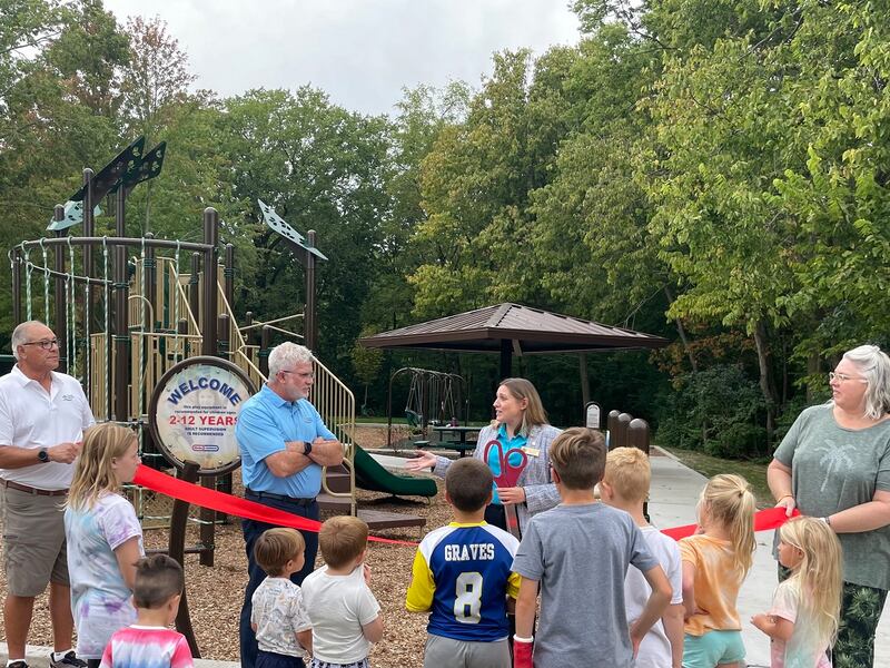State Sen. Rachel Ventura (holding the scissors) addresses Michael J. Leonard, executive director of the Channahon Park District, at the ribbon cutting ceremony for the opening of DuPage Park on Channahon on Tuesday, Sept. 23, 2025.