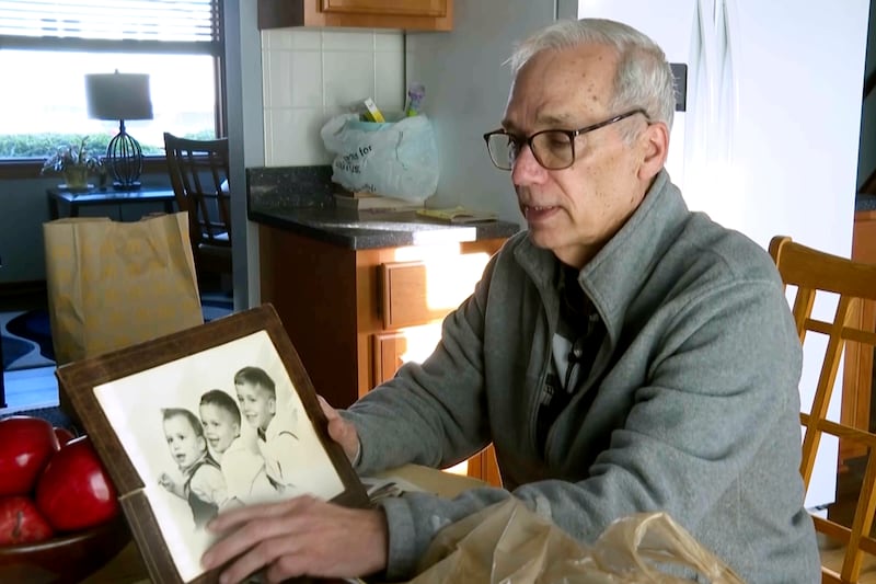 John Prevost, brother of new Pope Leo XIV, holds a portrait of the three Prevost brothers from 1958, Pope Leo, 3, left, John, 4, and Louis, 7, at his home Thursday, May 8, 2025, in New Lenox, Ill. (AP Photo/Obed Lamy)