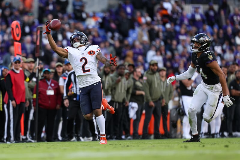 Chicago Bears wide receiver DJ Moore (2) makes a one-handed catch against Baltimore Ravens safety Kyle Hamilton (14) during the second half of an NFL football game, Sunday, Oct. 26, 2025, in Baltimore. (AP Photo/Terrance Williams)