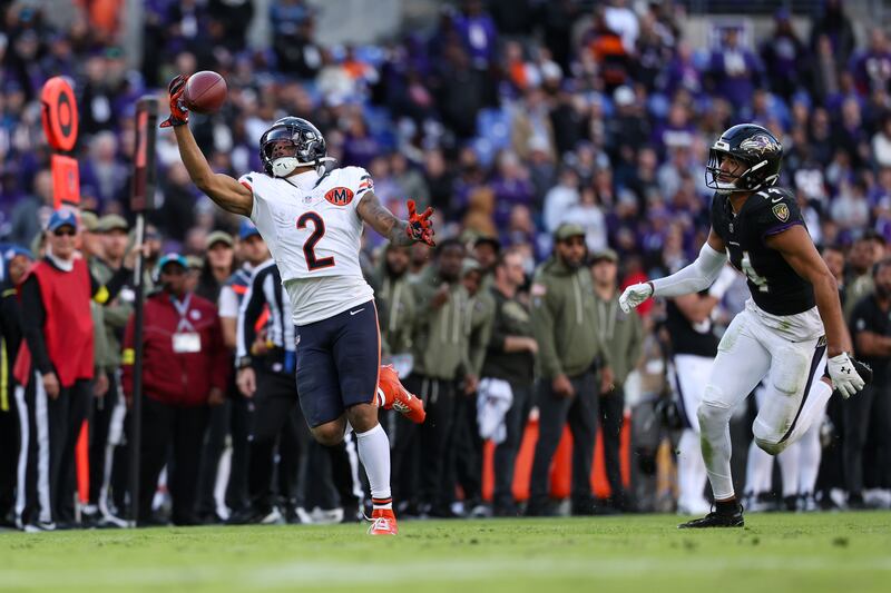 Chicago Bears wide receiver DJ Moore (2) makes a one-handed catch against Baltimore Ravens safety Kyle Hamilton (14) during the second half of an NFL football game, Sunday, Oct. 26, 2025, in Baltimore. (AP Photo/Terrance Williams)