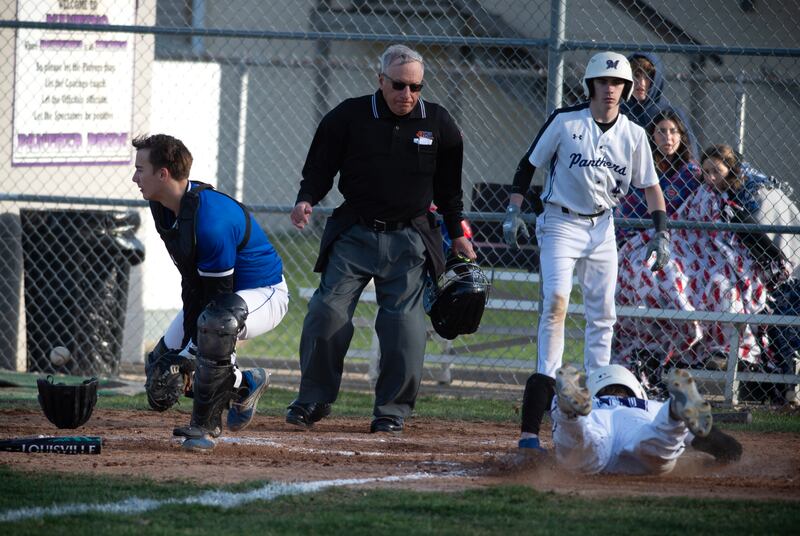 Manteno's Connor Harrod slides safely into home as Peotone's Everett Carder fields a late throw in the third inning of Monday's game.